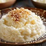 Creamy rice pudding served in a bowl with cinnamon sprinkled on top.