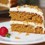 Moist and delicious carrot cake topped with cream cheese frosting, perfect for any occasion.